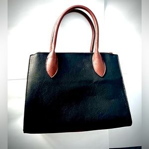 Black and brown hand purse. Slightly used in great condition.